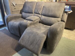 Gray fabric reclining loveseat with console.